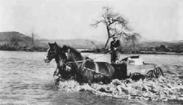 Joe Foster fording the swollen San Diego River. c.1916